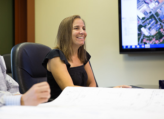 woman-sitting-conference-table-smiling